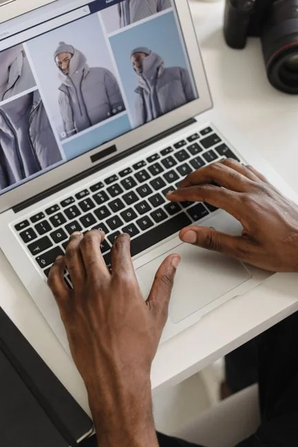 A person using a laptop to assess social media marketing strategies at home.